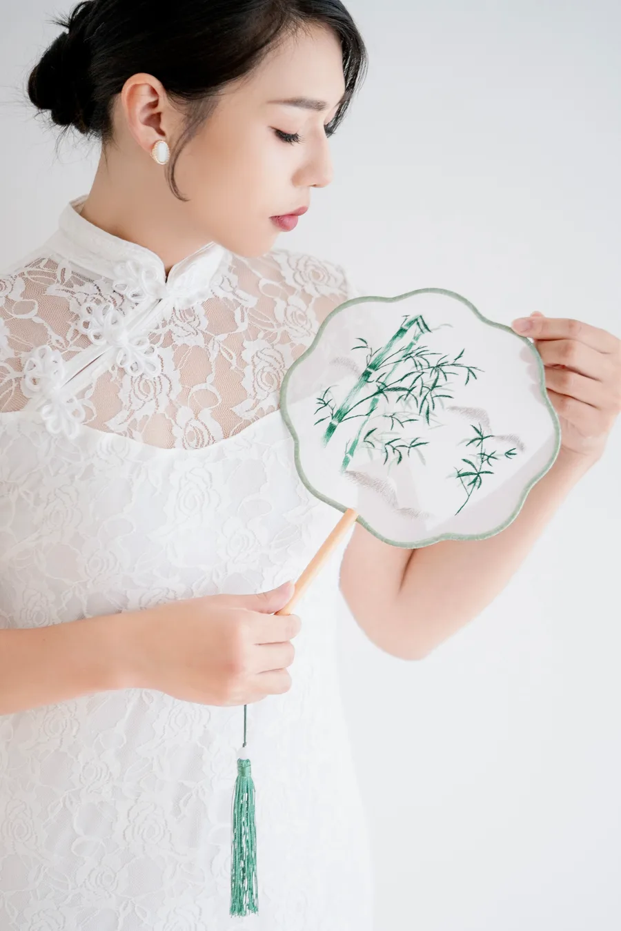 作品:穿白色蕾絲上衣、手拿團扇的女生
